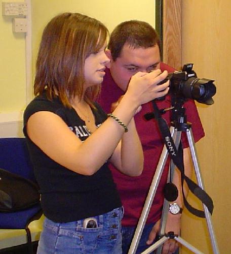 Anne Marie Evans and Terry Turner check photos for the web site.
